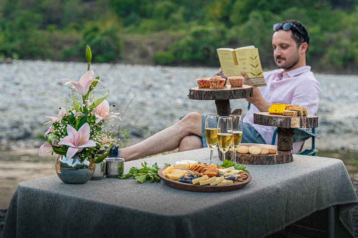 An outdoor picnic setup by the ramganga river