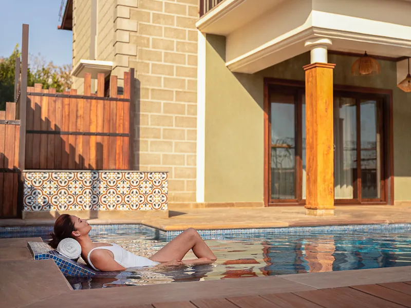 Relaxing in the hydrotherapy lounger in the private pool villa at aahana resort